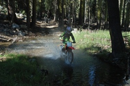 Brett crossing creek on dirt bike near Serene Lakes-04-d 7-31-07