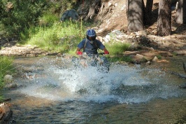 Craig Martens riding ATV across stream near Cascade Lake near Serene Lakes-02-2 8-4-07