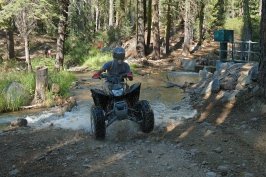 Craig Martens riding ATV across stream near Cascade Lake near Serene Lakes-04-d 8-4-07