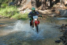 Eric Dahlstrom riding dirt bike across stream near Cascade Lake near Serene Lakes-02-2 8-4-07
