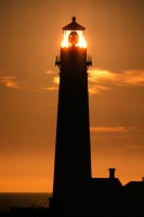 Sun setting behind Pigeon Pt lighthouse 11-85
