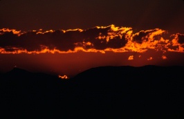 Dawn sun on clouds over White Mts from Mammoth 8-88