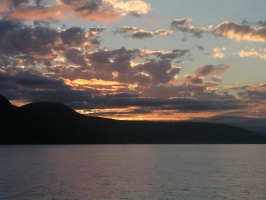 Sun setting over coastal mountains north of Port Douglas from QuickSilver catamaran AU 7-2-03